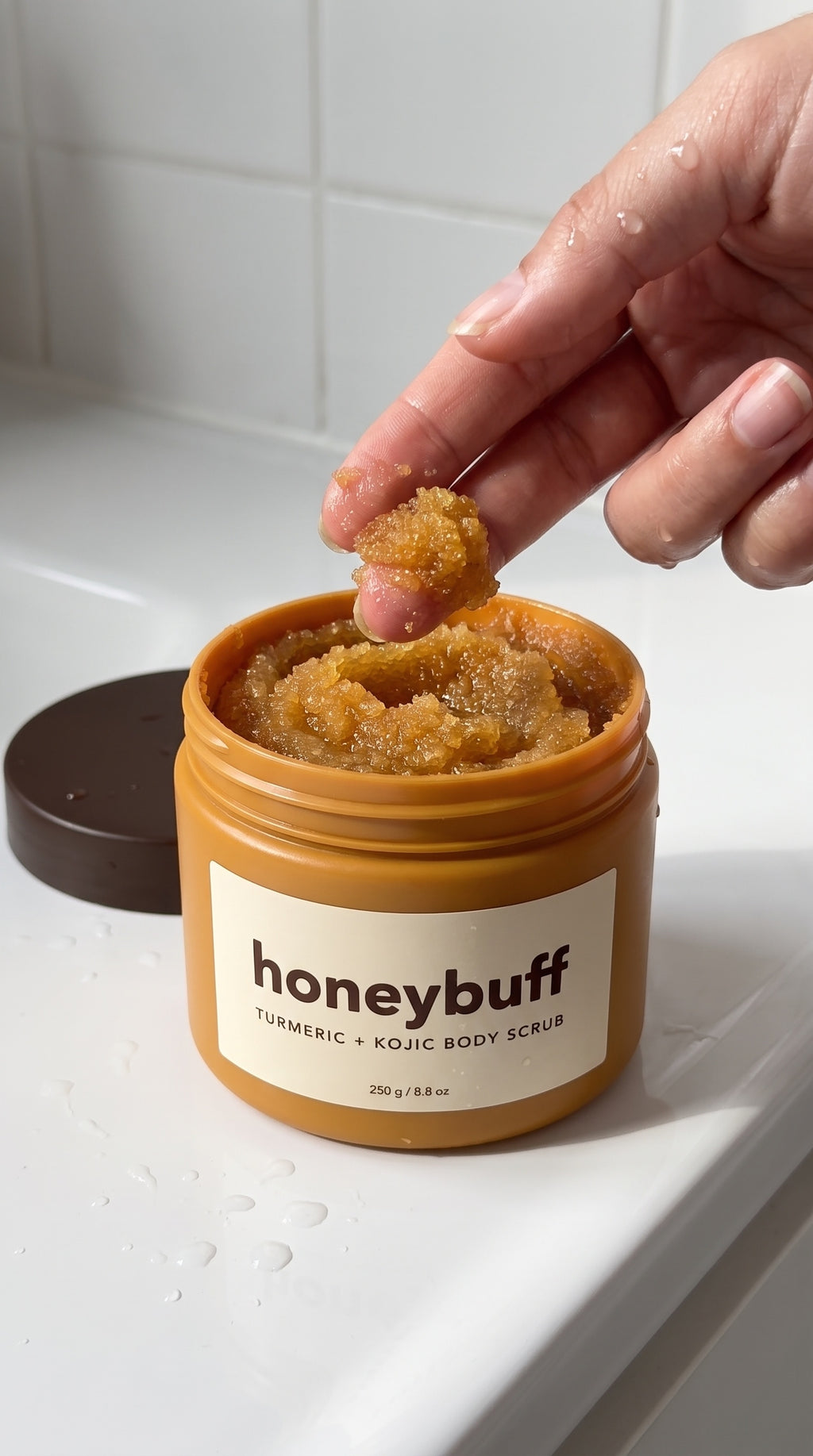 Honeybuff scrub texture on skin with water droplets